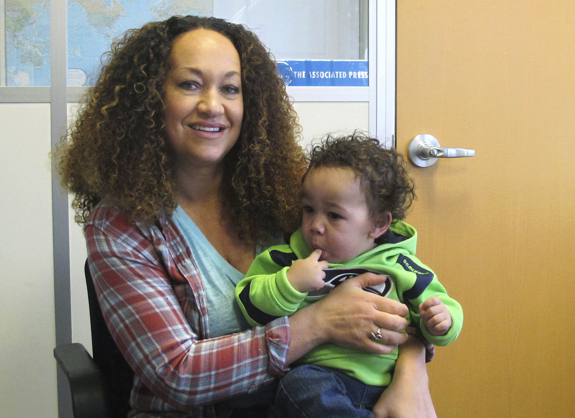 In this March 20, 2017 photo, Rachel Dolezal poses for a photo with her son, Langston in the bureau of the Associated Press in Spokane, Wash. Dolezal, who has legally changed her name to Nkechi Amare Diallo, rose to prominence as a black civil rights leader, but then lost her job when her parents exposed her as being white and is now struggling to make a living. (AP Photo/Nicholas K. Geranios) (AP)
