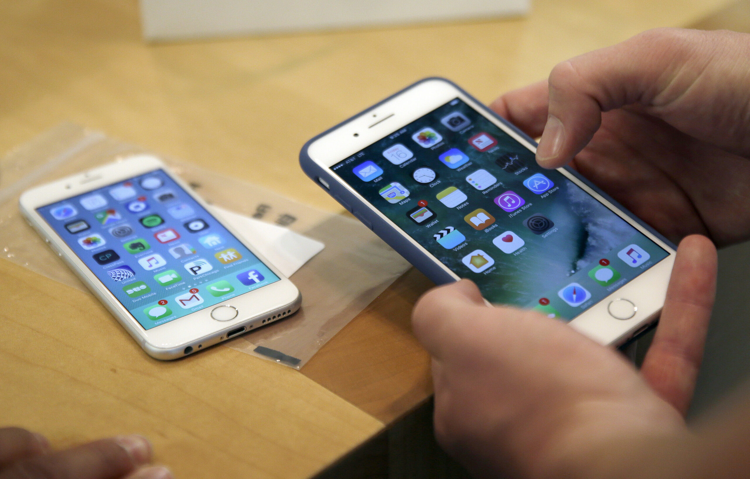 FILE - In this Friday, Sept. 16, 2016, file photo, a customer sets up his new iPhone 7 Plus, right, as he switches from the iPhone 6 at the Apple Store on Michigan Avenue during the release of the Apple iPhone 7 and the latest Apple Watches, in Chicago.  (AP Photo/Kiichiro Sato, File) (AP)