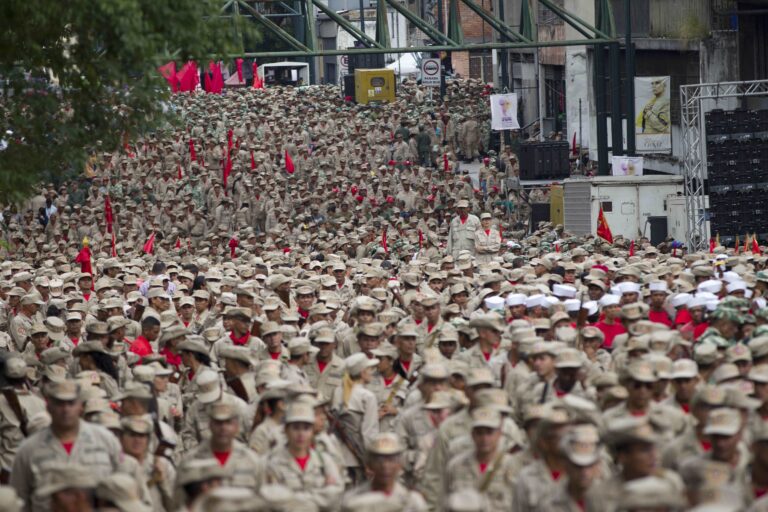 Members of the Bolivarian Militia march during their seventh anniversary celebration, in front of the Miraflores presidential palace in Caracas, Venezuela, Monday, April 17, 2017. Officially known as the Venezuelan National Bolivarian Militia, it is a branch of the National Armed Forces of Venezuela created by the late President Hugo Chavez. The anniversary celebration took place with unrest spreading in Venezuela as confrontations between opposition demonstrators and authorities continue. (AP Photo/Ariana Cubillos) (AP)