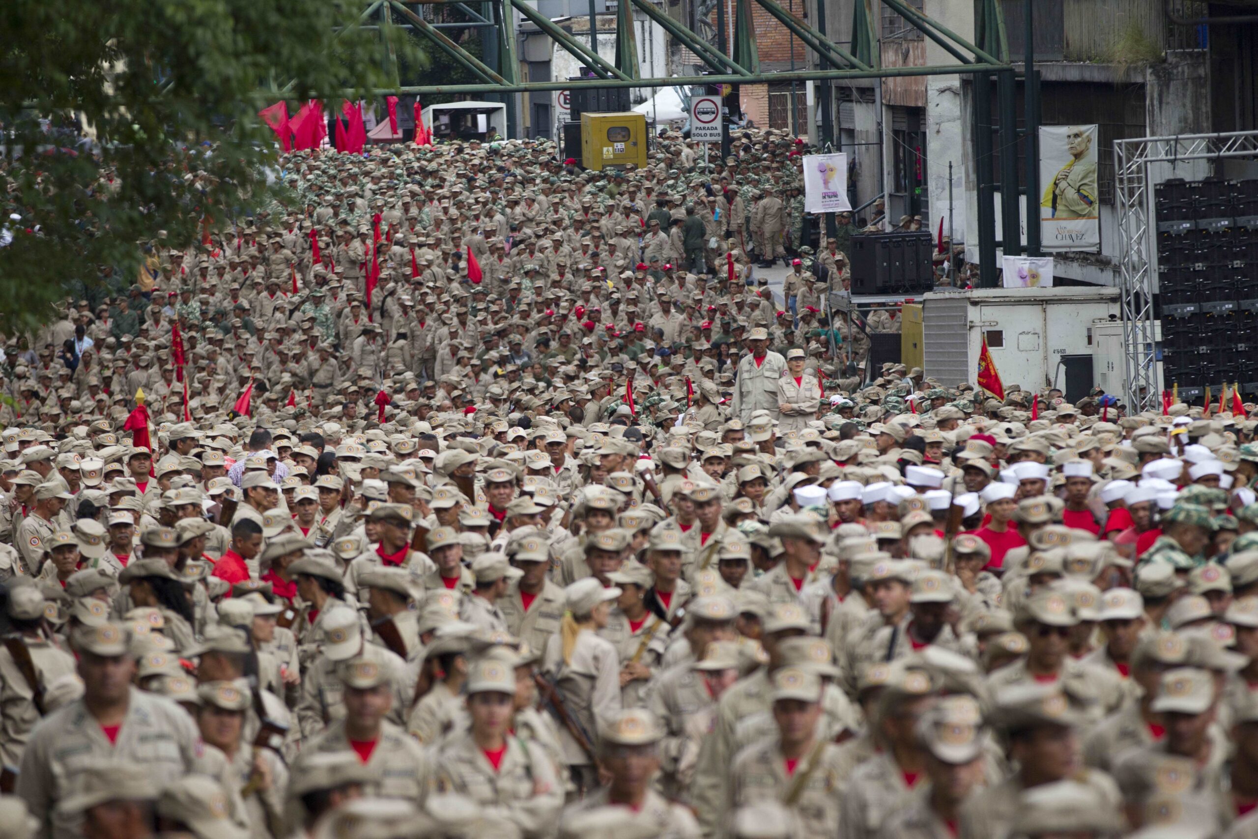 Members of the Bolivarian Militia march during their seventh anniversary celebration, in front of the Miraflores presidential palace in Caracas, Venezuela, Monday, April 17, 2017. Officially known as the Venezuelan National Bolivarian Militia, it is a branch of the National Armed Forces of Venezuela created by the late President Hugo Chavez. The anniversary celebration took place with unrest spreading in Venezuela as confrontations between opposition demonstrators and authorities continue. (AP Photo/Ariana Cubillos) (AP)