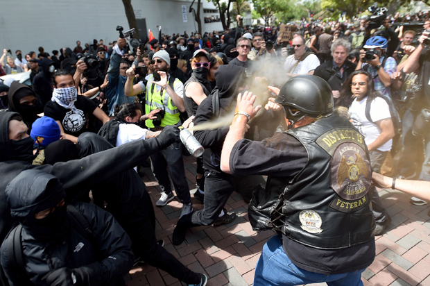 A man gets sprayed with a chemical irritant as multiple fights break out between Trump supporters and anti-Trump protesters in Berkeley, California on April 15, 2017. (Getty/Josh Edelson)