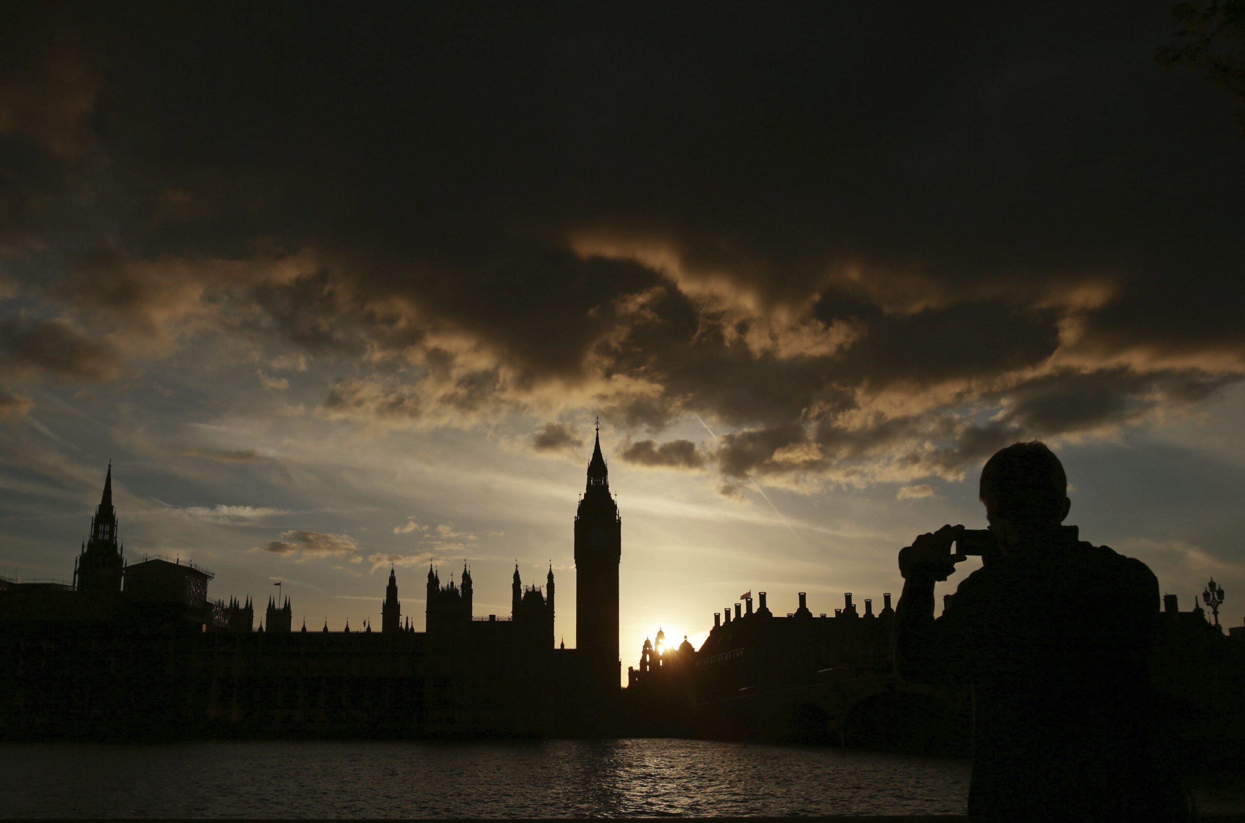 A silhouette of the Houses of Parliament and Elizabeth Tower containing Big Ben, centre, at dusk, in Westminster, London, Tuesday April 18, 2017. (Yui Mok/PA via AP)
