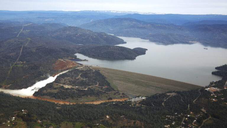 File - In this Saturday, Feb. 13, 2017, file photo, water flows down Oroville Dam's main spillway, near Oroville, Calif. Over six days, operators of the tallest dam in the United States, struggled to figure out their next move after raging floodwaters from California's wettest winter in decades gouged a hole the size of a football field in the dam's main water-release spillway. (AP Photo/Rich Pedroncelli, File) (AP)