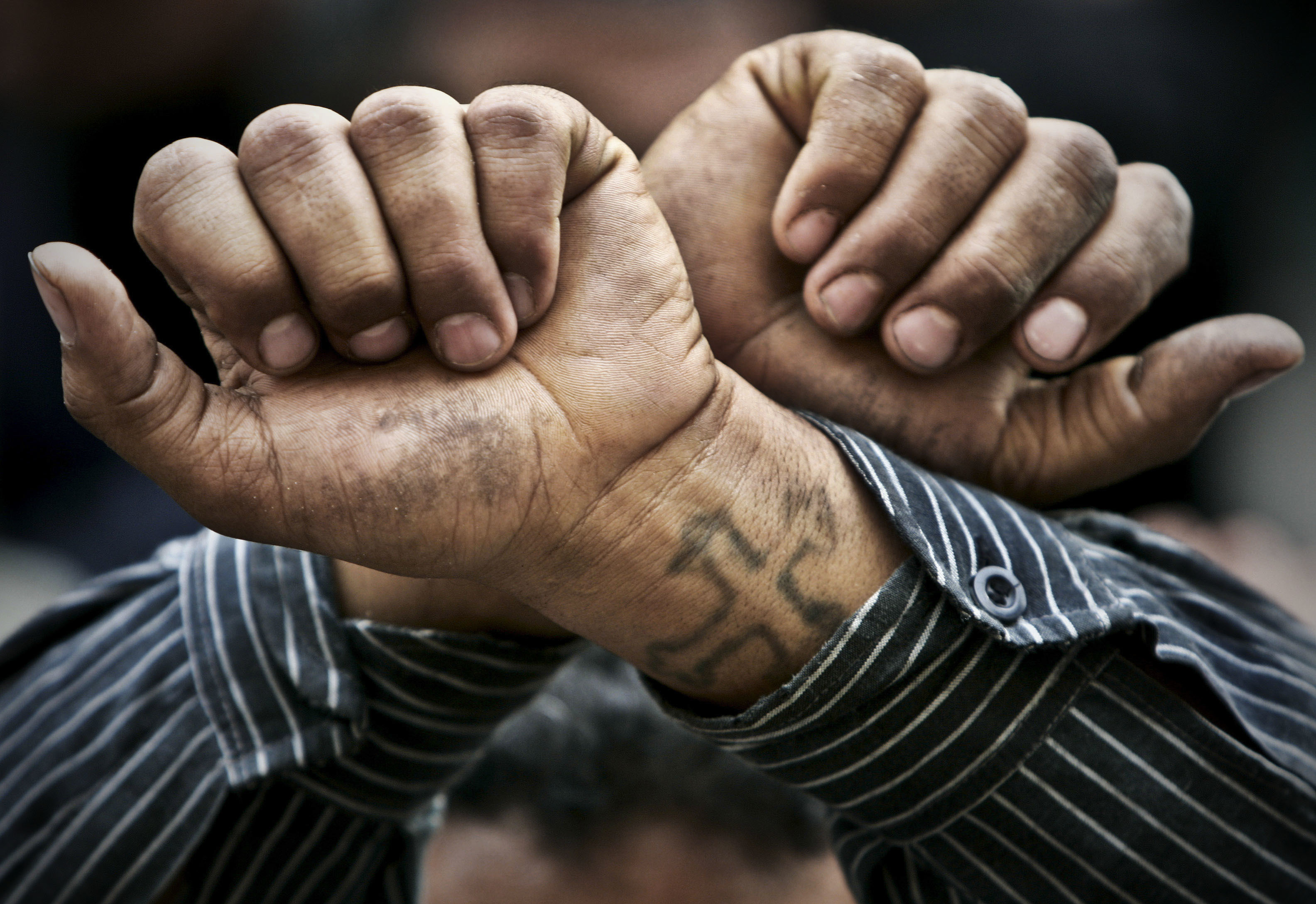 FILE - In this Friday, April 14, 2006 file photo, Egyptian Copts cross their wrists in defiance outside the Saints Church in the Sidi Bishr district of Alexandria in Egypt. Egypt’s Coptic Christians have become the preferred target of Islamic State radicals operating in the Arab world’s most populous nation, seeking to sow discord, undermine President Abdel-Fattah el-Sissi, and split the country. (AP Photo/Ben Curtis, File) (AP)