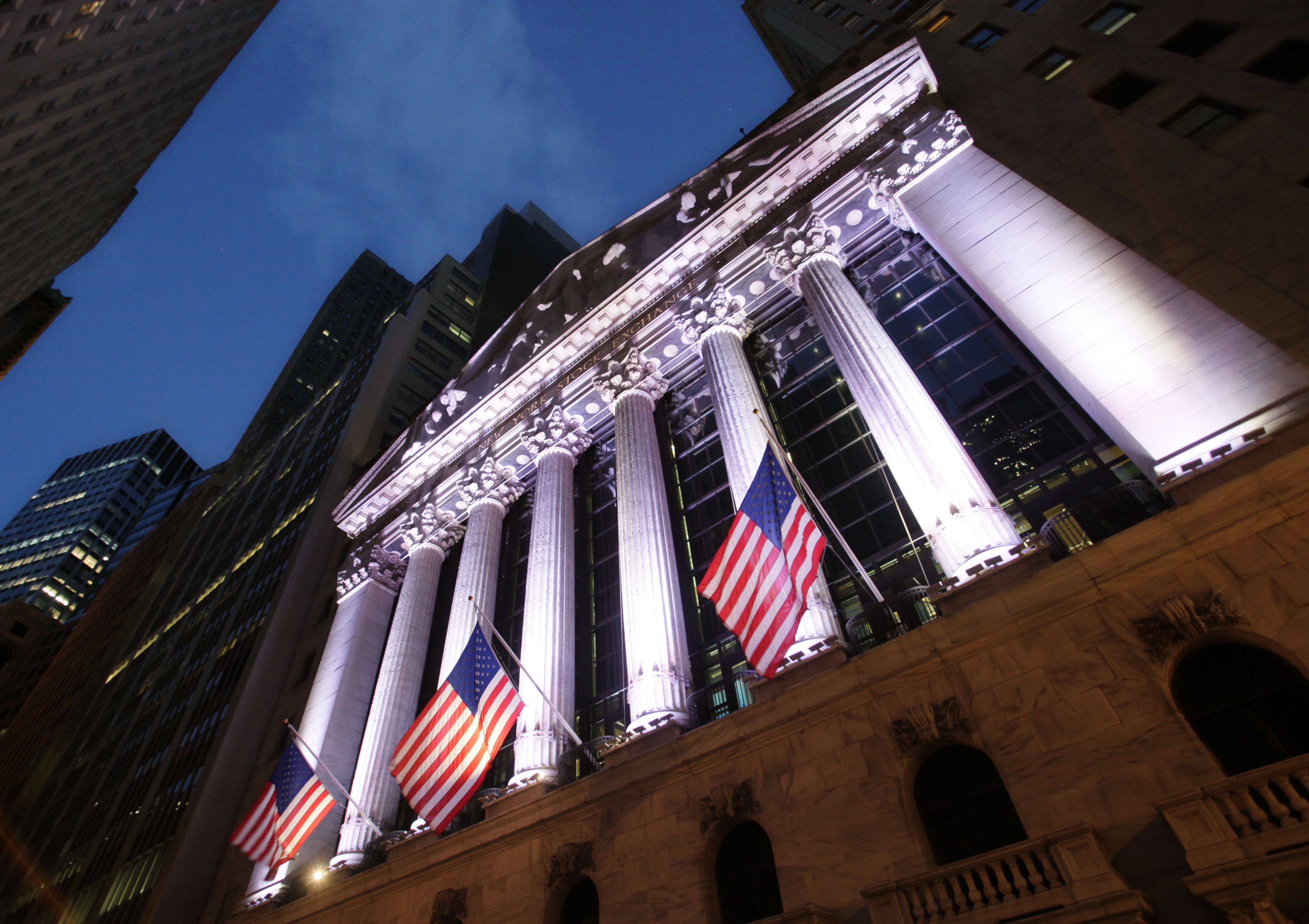 FILE - In this Oct. 8, 2014, file photo, American flags fly in front of the New York Stock Exchange. World stocks fell Tuesday, April 18, 2017, amid concerns about the security situation on the Korean Peninsula, France's upcoming presidential election, and Britain's surprise decision to hold a general election. (AP Photo/Mark Lennihan, File) (AP)