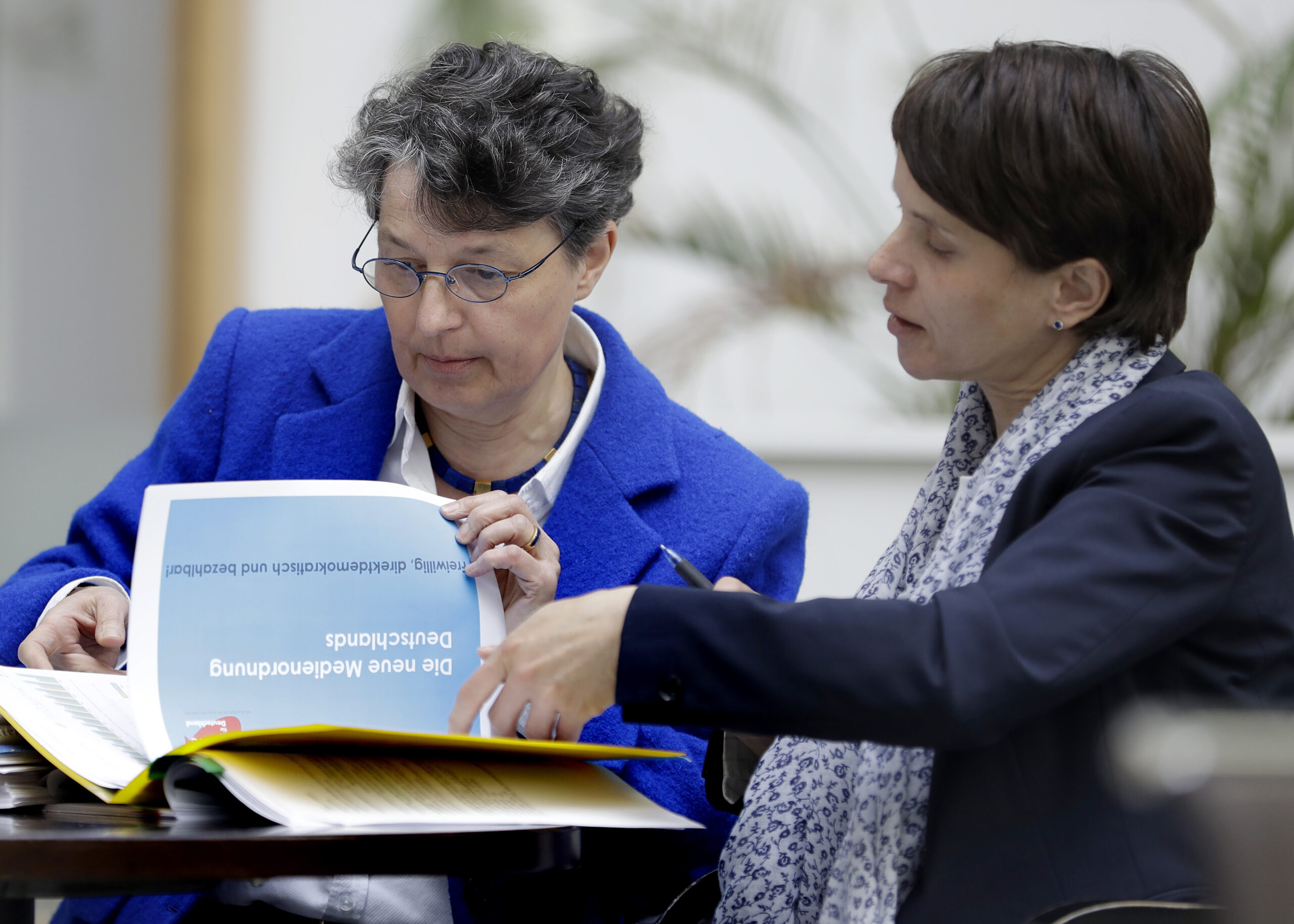 AfD (Alternative for Germany) chairwomen and party's faction leader in the German state parliament of Saxony, Frauke Petry, right, and the faction's media policy spokeswomen, Kirsten Muster, left, talk as they arrive for a press conference in Berlin, Germany, Tuesday, April 18, 2017. (AP Photo/Michael Sohn) (AP)