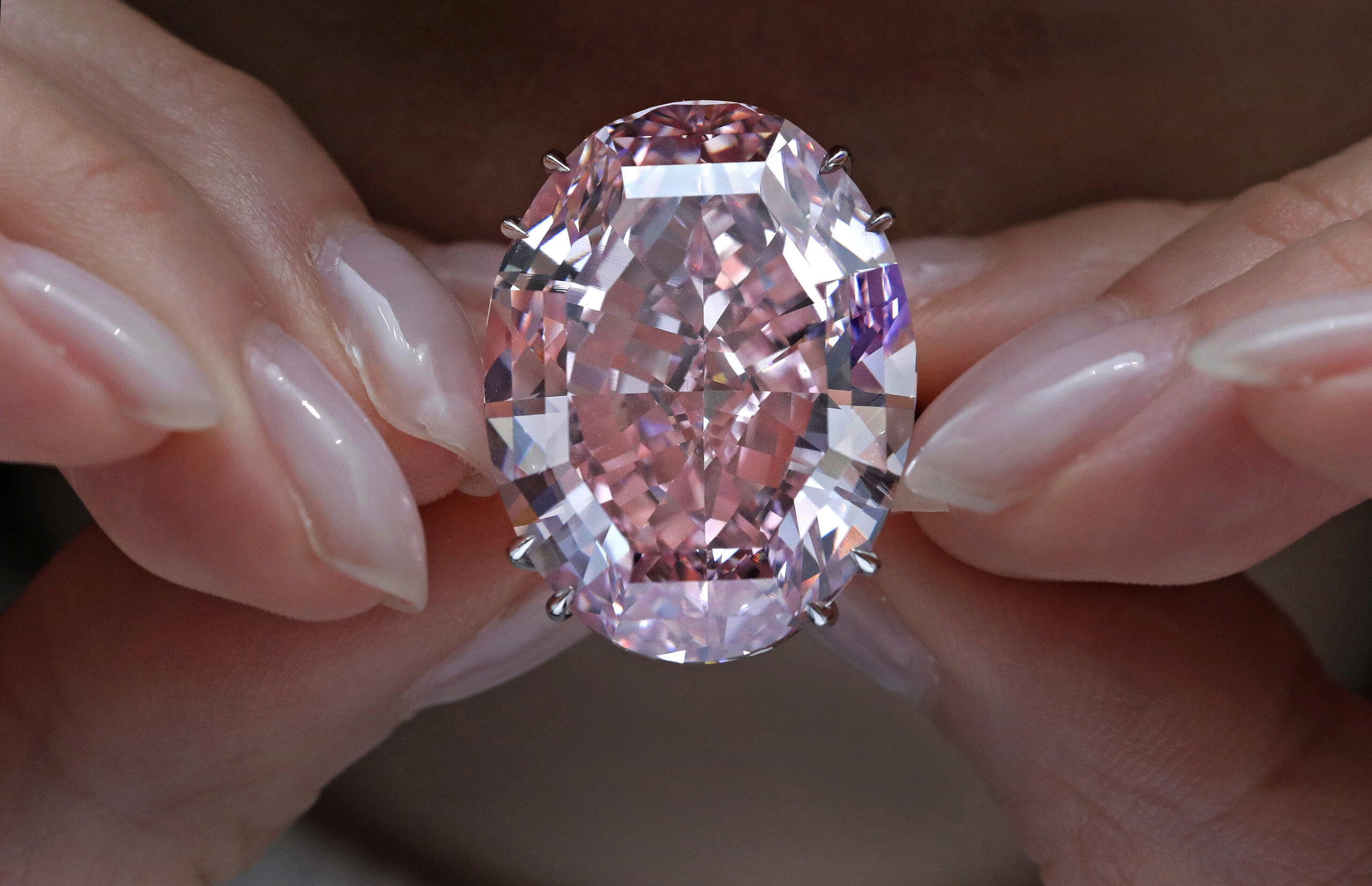 FILE - In this Wednesday, March 29, 2017, file photo, the "Pink Star" diamond, the most valuable cut diamond ever offered at auction, is displayed by a model at a Sotheby's auction room in Hong Kong. The stunning 59.6 carat diamond has sold for HK$553 million or US$71.2 million at a Sotheby's auction in Hong Kong, setting a record for any diamond or jewel. It's Also the highest price for any work ever sold at auction in Asia. (AP Photo/Vincent Yu, File) (AP Photo/Vincent Yu, File)