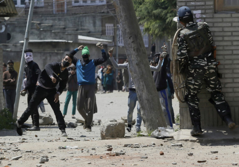 Kashmiri protesters throw stones on Indian security men outside a poling station during a by-election to an Indian Parliament seat in Srinagar, Indian controlled Kashmir, Sunday, April. 9, 2017. (AP Photo/Mukhtar Khan) (AP)