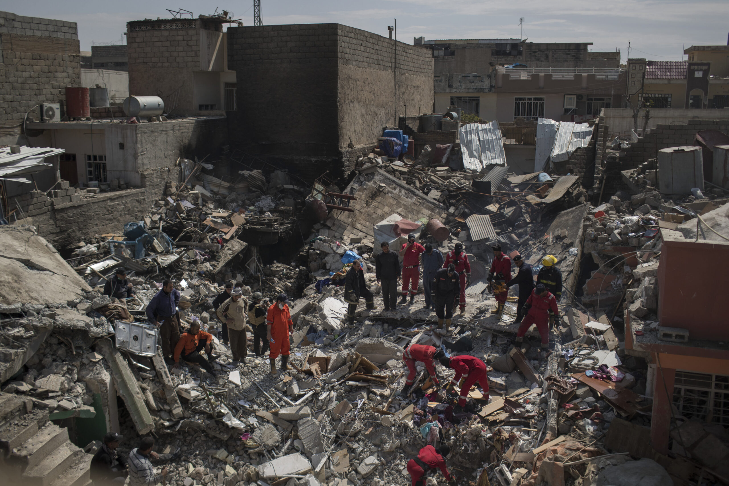 Civil protection rescue teams work on the debris of a destroyed house to recover the body of people killed in an airstrike during fighting between Iraqi security forces and Islamic State militants on the western side of Mosul, Iraq. (AP Photo/Felipe Dana, File)