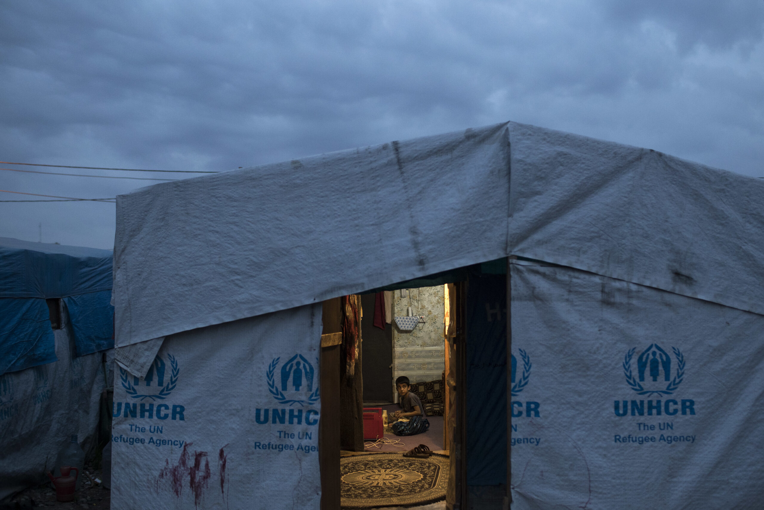 A Syrian boy sits inside his tent in the Kawergosk refugee camp in northern Iraq, Saturday, April 8, 2017. (AP Photo/Felipe Dana)