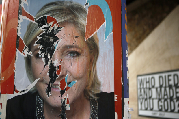 A torn campaign poster of Marine Le Pen is pictured in Paris, Thursday, April 27, 2017. (AP/Francois Mori)