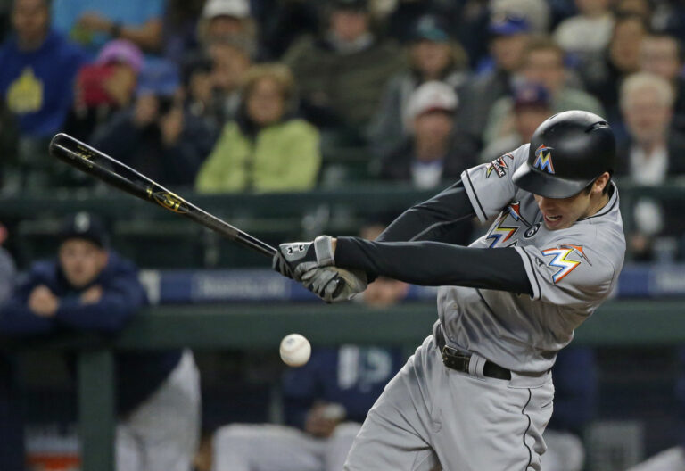 Miami Marlins' Christian Yelich hits an RBI single to score Dee Gordon in the first inning of a baseball game against the Seattle Mariners, Tuesday, April 18, 2017, in Seattle. (AP Photo/Ted S. Warren) (AP)