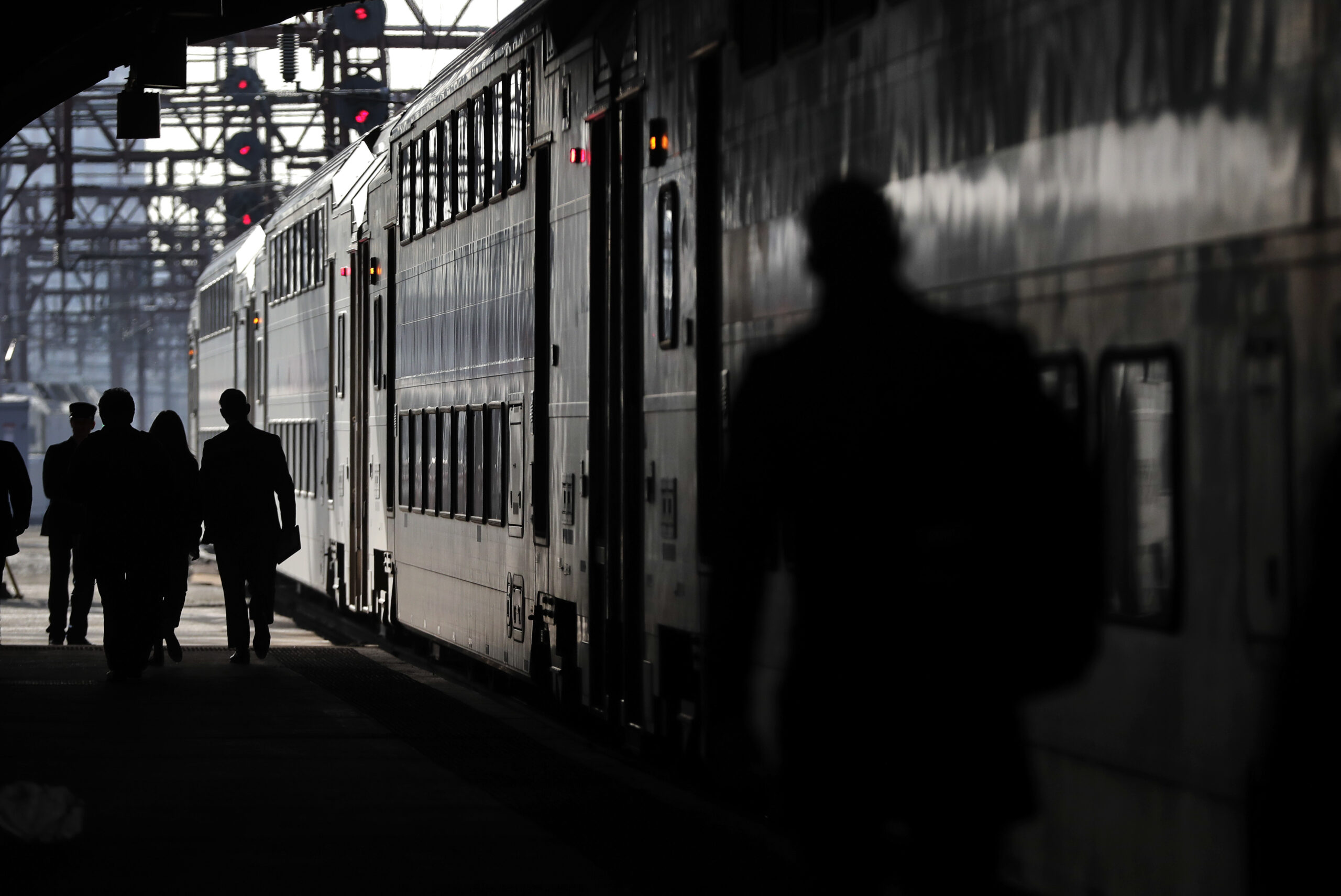 New Jersey Transit commuters walk along a platform to catch a train heading for Dover, N.J., Wednesday, April 5, 2017, in Hoboken, N.J. The heads of the two major commuter rail lines that use New York's Penn Station took turns criticizing Amtrak on Wednesday for two recent derailments that continued to cause headaches for commuters in the nation's busiest rail hub. (AP Photo/Julie Jacobson) (AP)