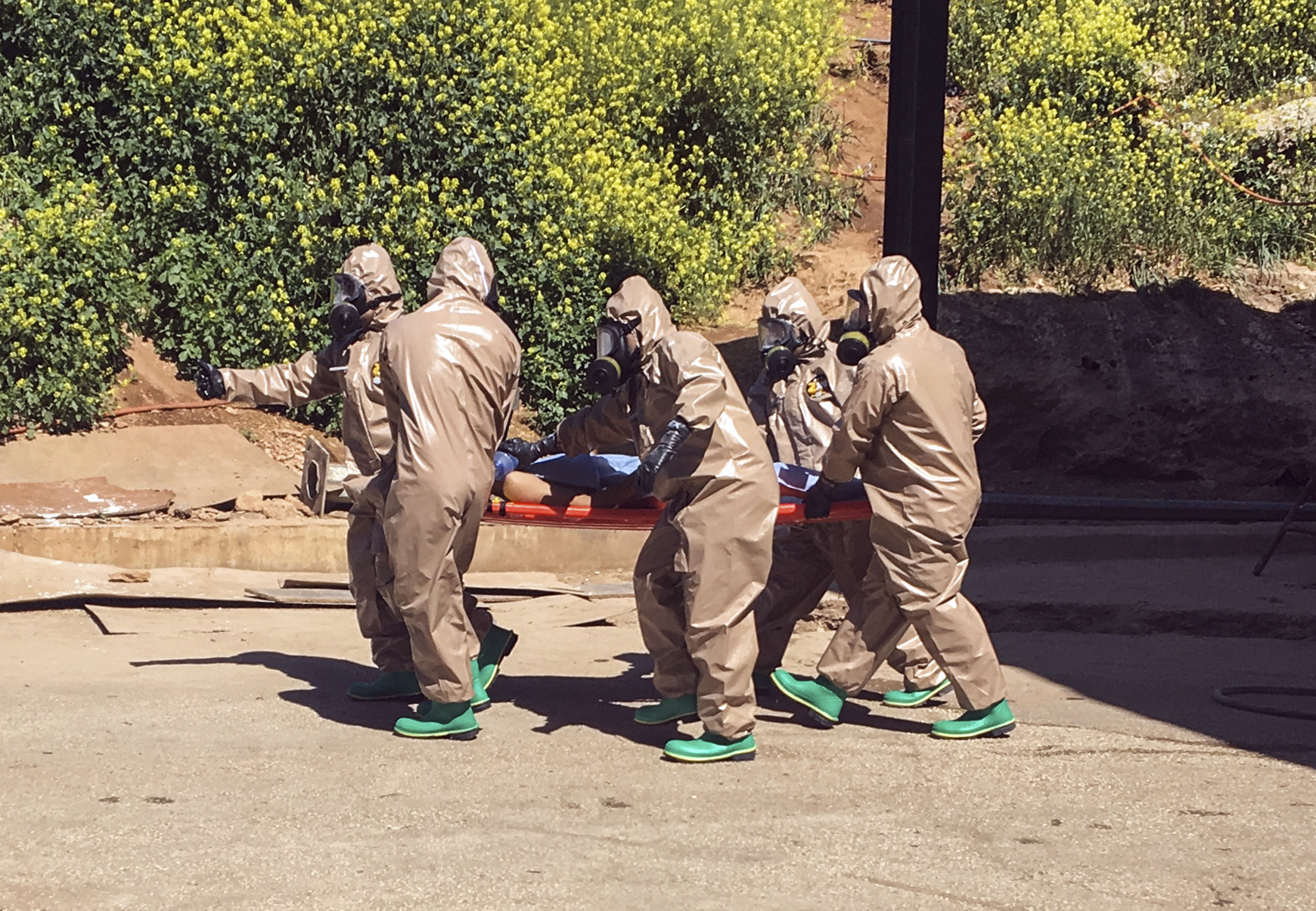 In this photo taken on Tuesday, April 4, 2017 and made available Wednesday, April 5, Turkish experts carry a victim of alleged chemical weapons attacks in Syrian city of Idlib, at a local hospital in Reyhanli, Hatay, Turkey.  A suspected chemical attack in a town in Syria's rebel-held northern Idlib province killed dozens of people on Tuesday, opposition activists said, describing the attack as among the worst in the country's six-year civil war.(AP Photo) (AP)