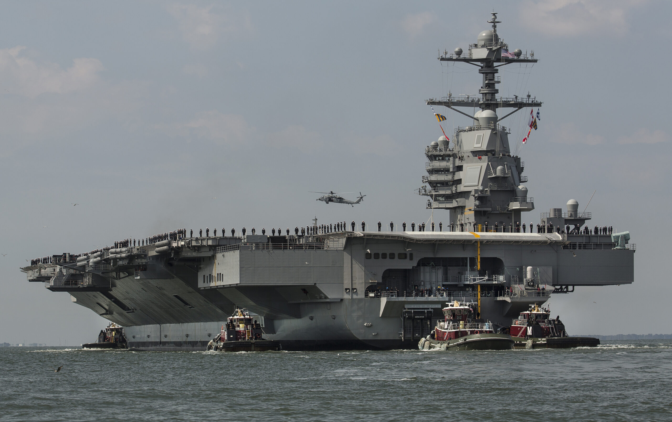 As crew members stand on the deck, the aircraft carrier USS Gerald R. Ford heads to the Norfolk, Va., naval station on Friday, April 14, 2017 after almost a week of builder's trials during which the ships systems were tested. (Bill Tiernan/The Virginian-Pilot via AP) (AP)