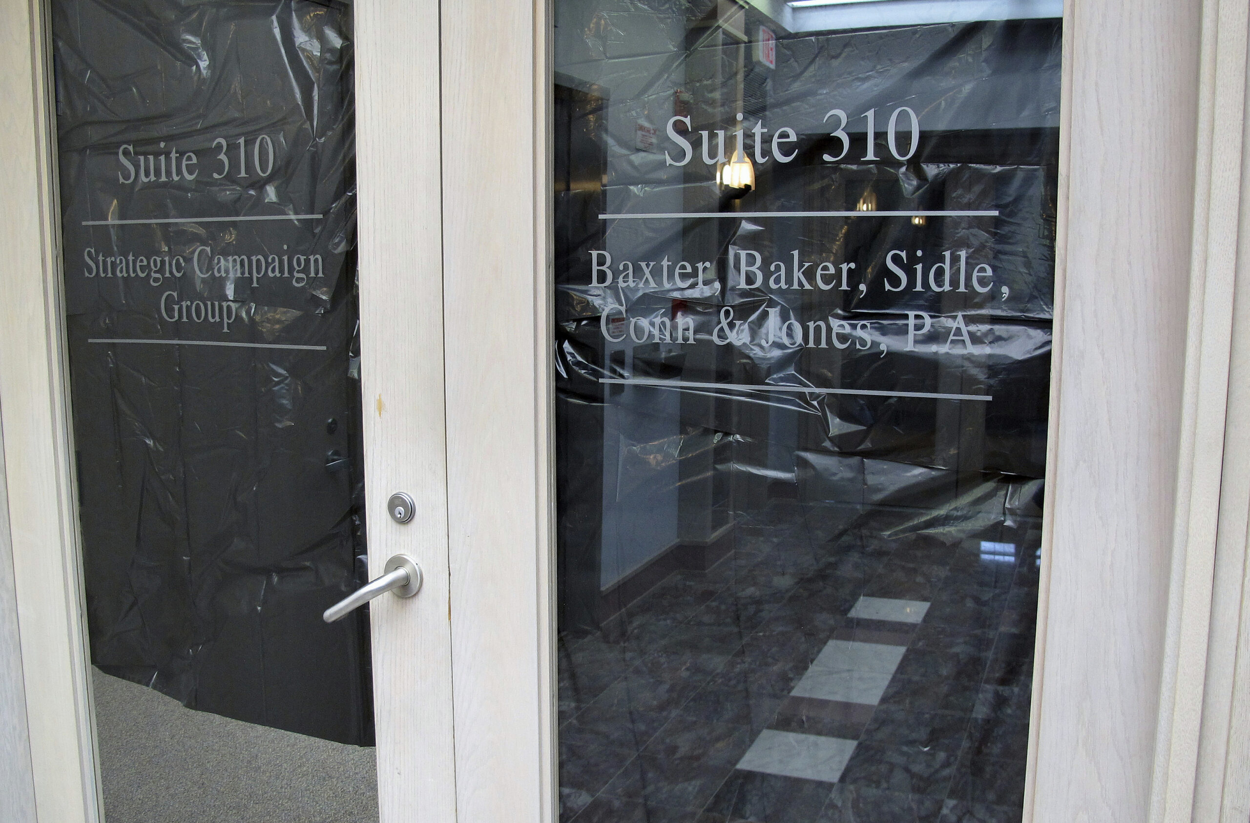 Windows in the doors of a Republican political consulting firm, Strategic Campaign Group, on Thursday, May 11, 2017 in Annapolis, Md. (AP Photo/Brian Witte)