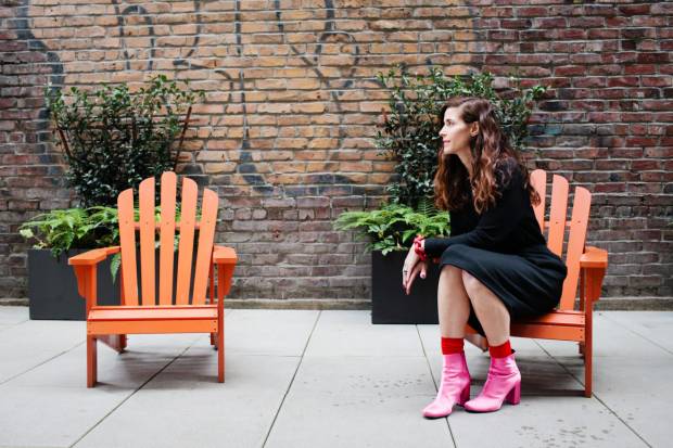 April Pride poses in the well-curated passageway of the downtown building where Van der Pop is located in Seattle. (Kristen Angelo/Narratively)