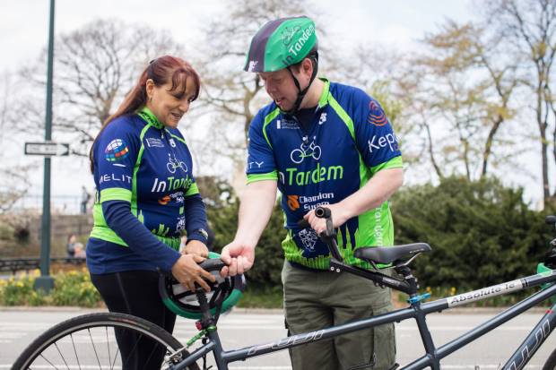 Conde and her “captain,” James Sweeney, preparing for a ride. (Daniel Krieger/Narratively)
