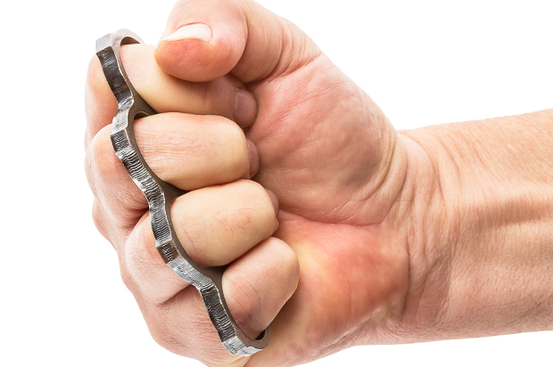 Fist with brass knuckles isolated on white background (Getty Images/istockphoto)