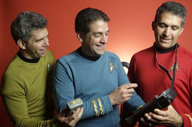 Dr. Basil Harris, flanked by his brothers George, at left, and Constantine (Gus), pose in “Star Trek” uniforms and tricorder props from the popular science fiction franchise. (XPRIZE)