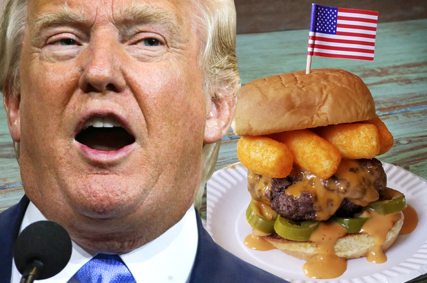 Donald Trump next to his namesake burger. (AP/Mark Humphrey/George Motz)
