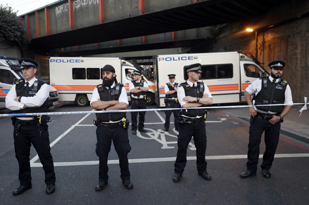 Police stand guard at a cordon on a road near Finsbury Park station after a vehicle struck pedestrians in north London, Monday, June 19, 2017. (AP/Tim Ireland)