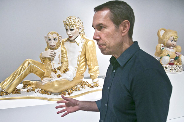 Jeff Koons near his sculptures "Michael Jackson and Bubbles," and "Amore" (AP/Bebeto Matthews)