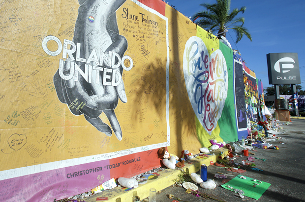 Artwork and signatures cover a fence around the Pulse nightclub (AP/John Raoux)