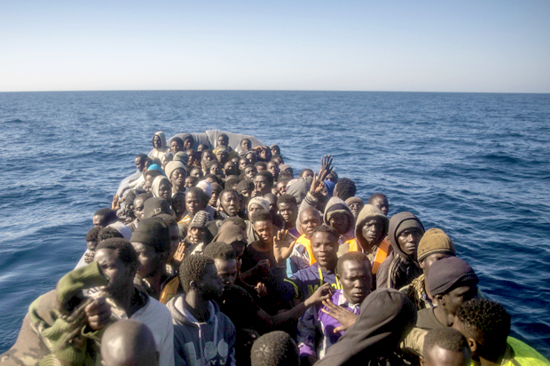 Refugees wait to be assisted. (AP/Santi Palacios)