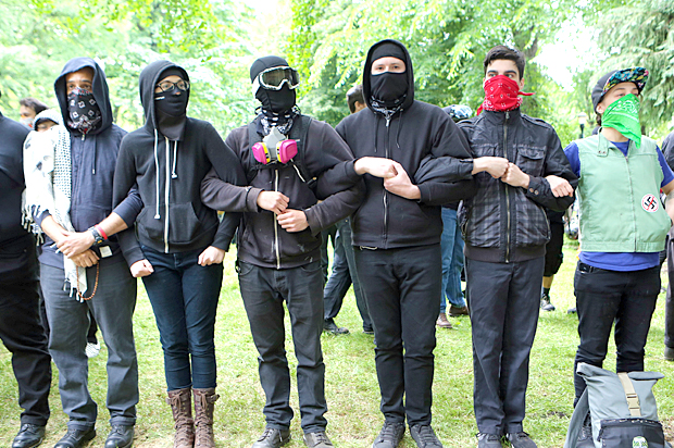 'Antifa' protesters link arms as they demonstrate at a rally (Getty/Natalie Behring)