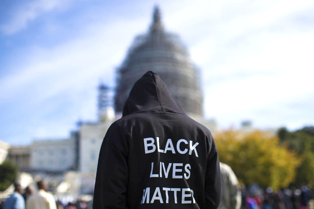 A man wears a "Black Lives Matter" hoodie as he stands on the Capitol building lawn (AP/Evan Vucci)