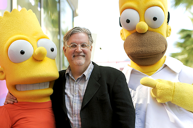 Matt Groening, creator of "The Simpsons," poses with his character creations Bart Simpson and Homer Simpson (AP/Chris Pizzello)