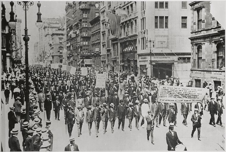 Silent Protest parade on Fifth Avenue, New York City, July 28, 1917, in response to the East St. Louis race riot. In front row are James Weldon Johnson (far right), W. E. B. DuBois (2nd from right), Rev. Hutchens Chew Bishop, rector of St. Philip's Episcopal Church (Harlem) and realtor John E. Nail. (New York Public Library (public domain))