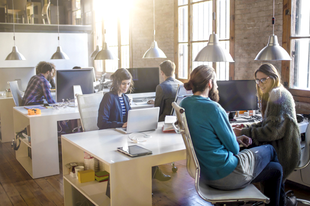 Young creative business people working in the office late in the afternoon. (Getty/xavierarnau)