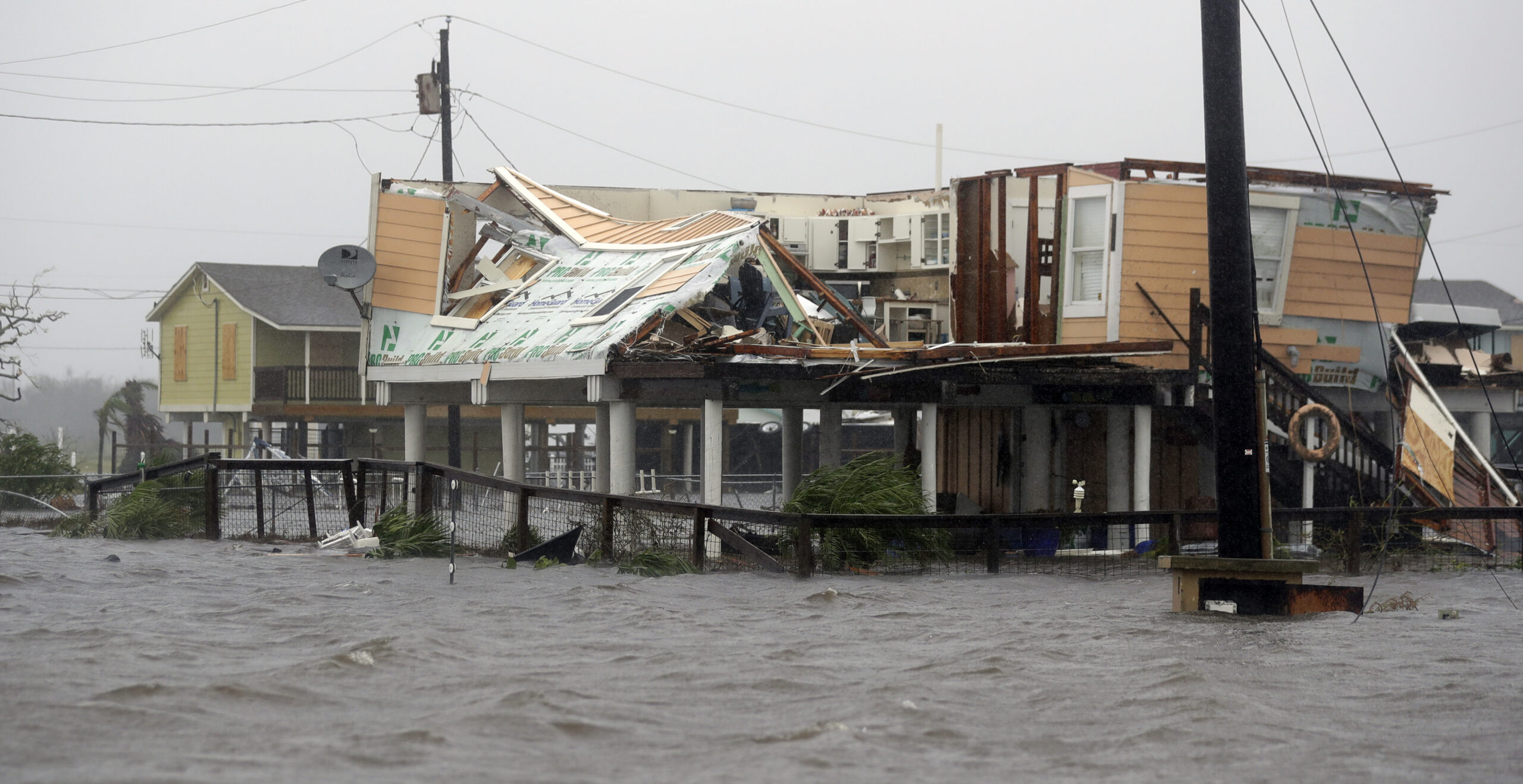 Flood water surround homes damaged by Hurricane Harvey, Saturday, Aug. 26, 2017, in Rockport, Texas. (AP Photo/Eric Gay)