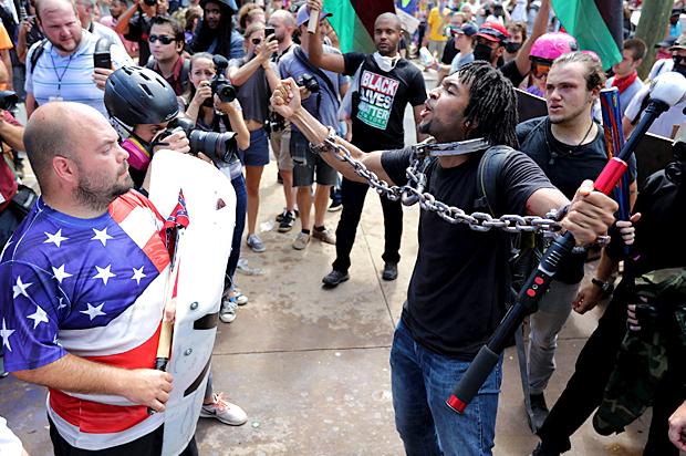 White nationalists, neo-Nazis and members of the "alt-right" exchange insluts with counter-protesters as they attempt to guard the entrance to Emancipation Park during the "Unite the Right" rally. (Getty/Chip Somodevilla)