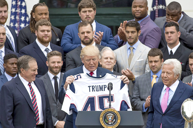 President Donald Trump is presented with a New England Patriots jersey (AP/Andrew Harnik)
