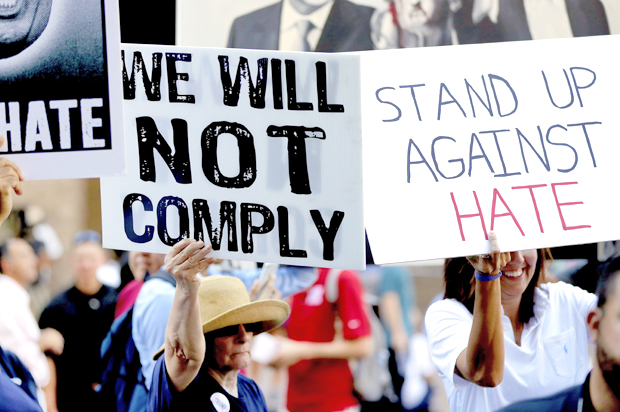People protest outside the Phoenix Convention Center, Tuesday, Aug. 22, 2017. (AP/Matt York)