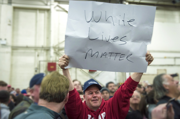 A Trump supporter holds up a "White Lives Matter" sign (Getty/Andrew Renneisen)