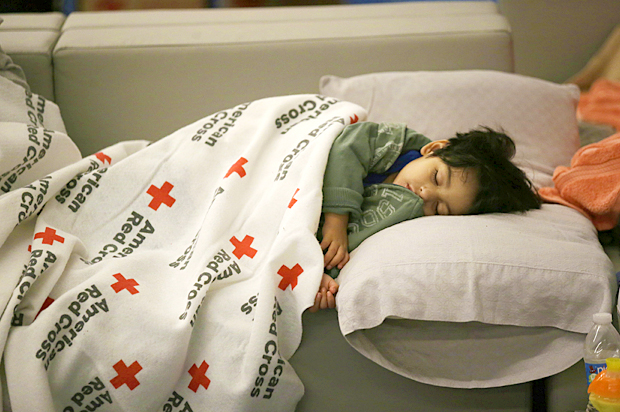 Malachia Medrano, 2, sleeps under a donated blanket at a shelter for Tropical Storm Harvey evacuees (AP/LM Otero)