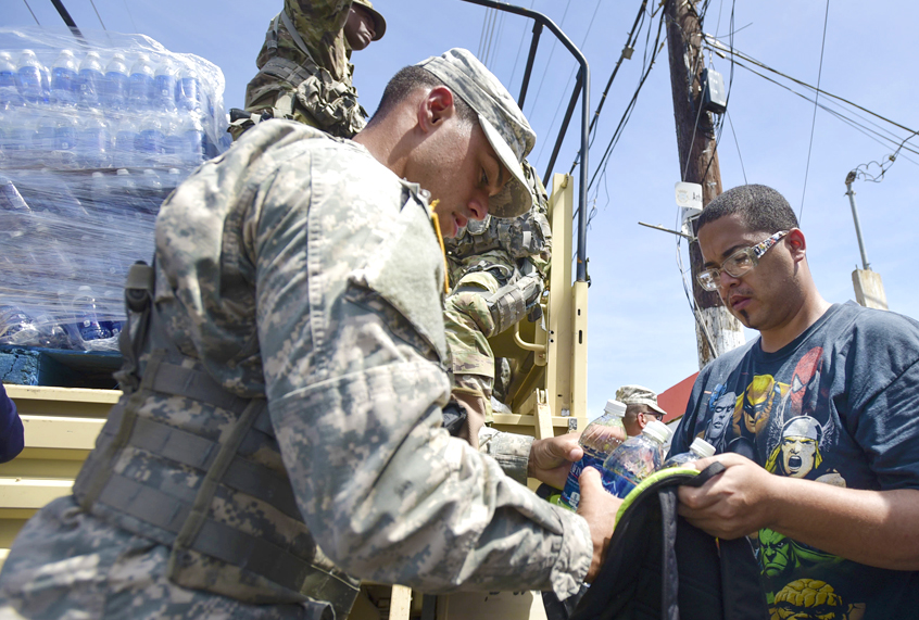 National Guardsmen distribute water and food among after Hurricane Maria in Puerto Rico (AP/Carlos Giusti)