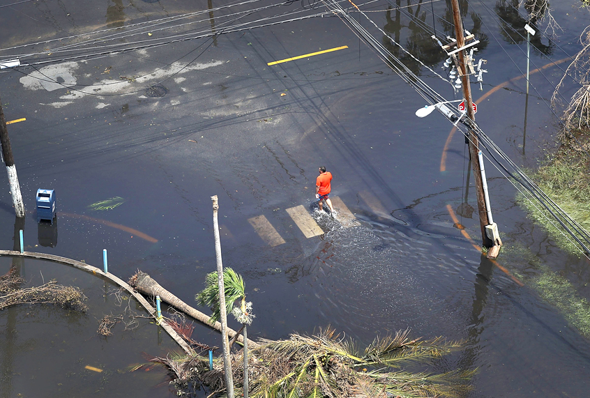 A man walks through a flooded street after Hurricane Maria in San Juan, Puerto Rico. (Getty/Joe Raedle)