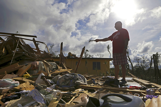 Jose Garcia Vicente holds a piece of plumbing he picked up, as he shows his destroyed home, in the aftermath of Hurricane Maria, in Aibonito, Puerto Rico, Monday, Sept. 25, 2017. The U.S. ramped up its response Monday to the humanitarian crisis in Puerto Rico while the Trump administration sought to blunt criticism that its response to Hurricane Maria has fallen short of it efforts in Texas and Florida after the recent hurricanes there. (AP Photo/Gerald Herbert) (AP)