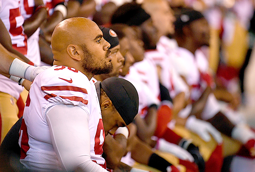 Members of the San Francisco 49ers kneel during the National Anthem before the game against the Indianapolis Colts (Getty/Bobby Ellis)