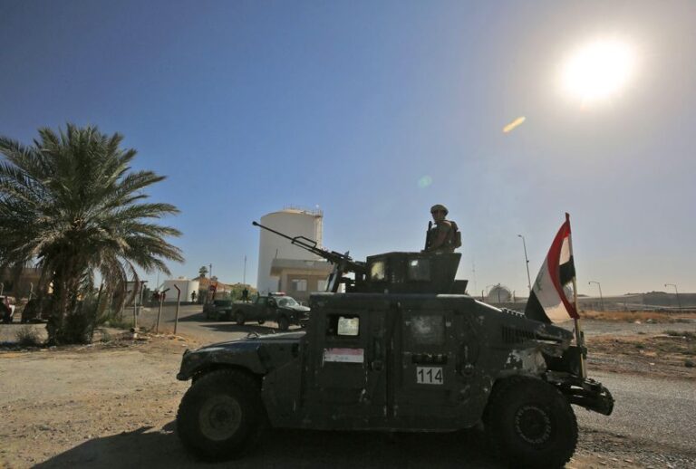 A member of the Iraqi government forces stands guard in a humvee turret while guarding the Bai Hassan oil field, west of Kirkuk, October 19, 2017. (Getty/Ahmad Al-Rubaye)
