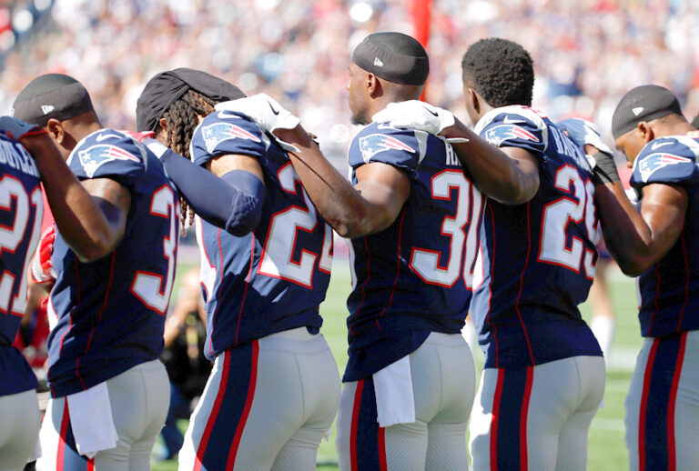 New England Patriots players stand for the national anthem (Getty/Jim Rogash)