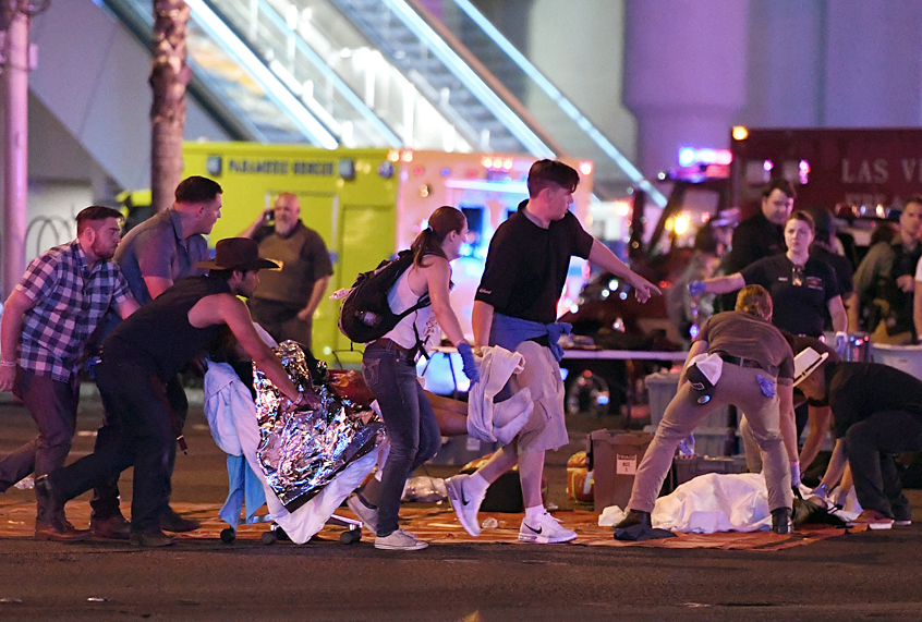 An injured person is tended to after a mass shooting at a country music festival on October 2, 2017 (Getty/Ethan Miller)