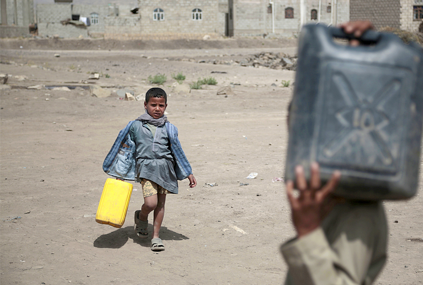 Boys carry buckets to fill with water from a well that is alleged to be contaminated water with the bacterium Vibrio cholera, on the outskirts of Sanaa, Yemen. (AP/Hani Mohammed)