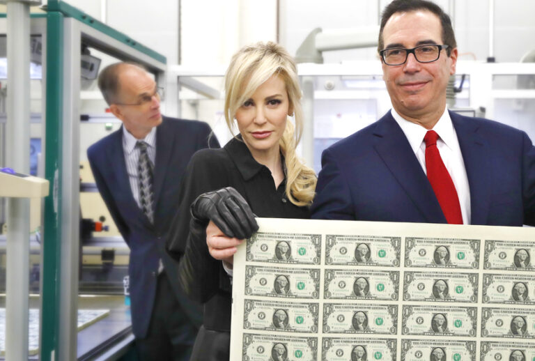 Louise Linton and Steven Mnuchin hold up a sheet of new $1 bills. (AP/Jacquelyn Martin)