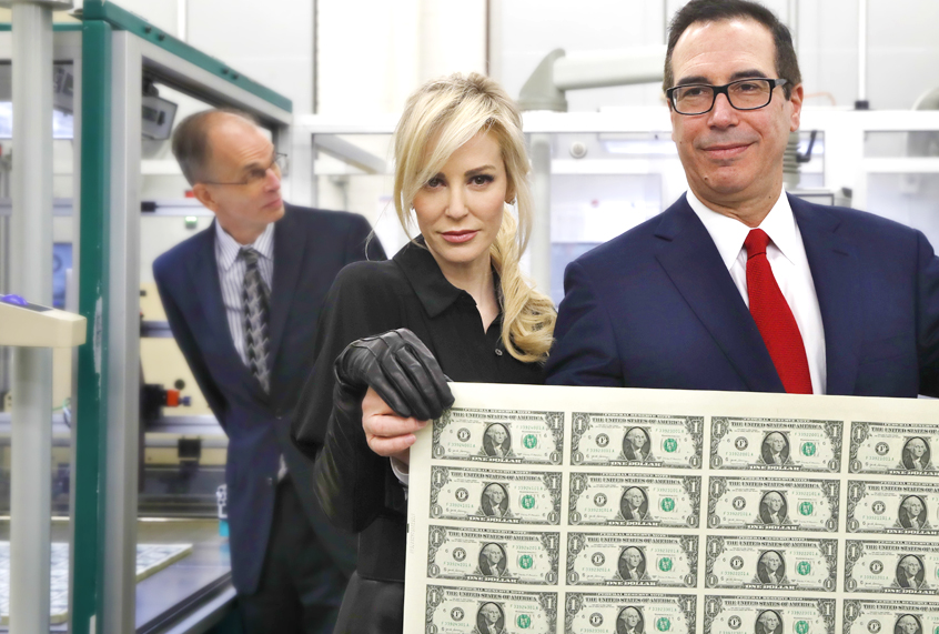 Louise Linton and Steven Mnuchin hold up a sheet of new $1 bills. (AP/Jacquelyn Martin)